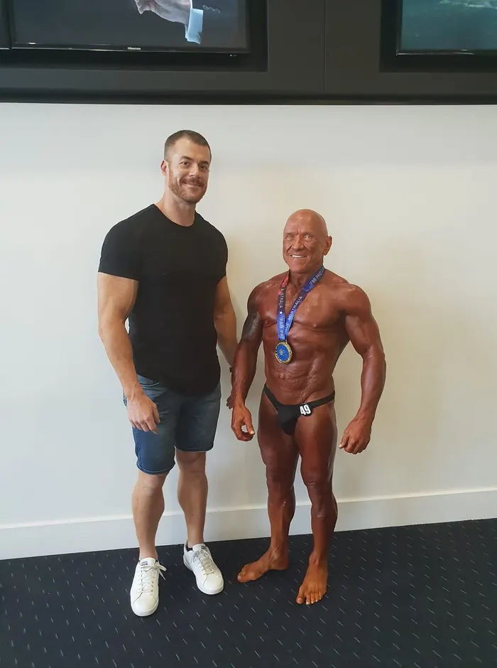Michael Lea with a bodybuilding competitor he coached